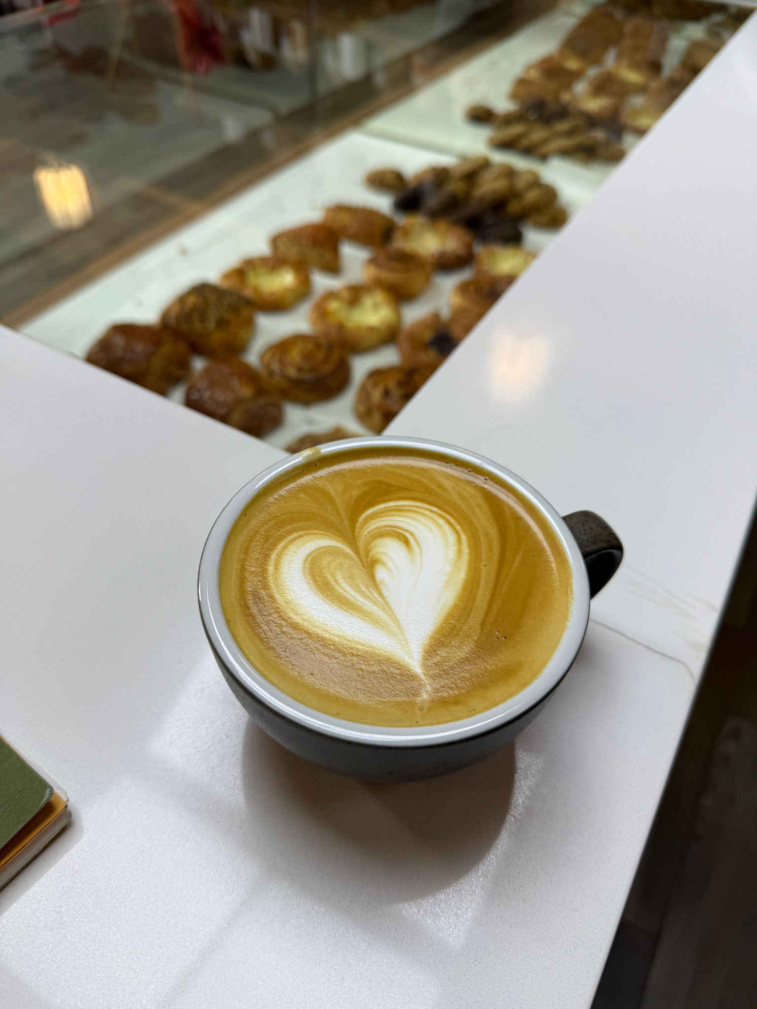 Assortment of pastries and coffee drinks on a marble table